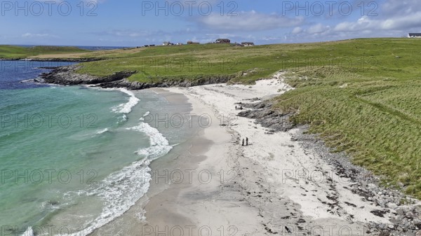 An idyllic coastal landscape with a sandy beach and green meadow under a blue sky, Meal Beach,