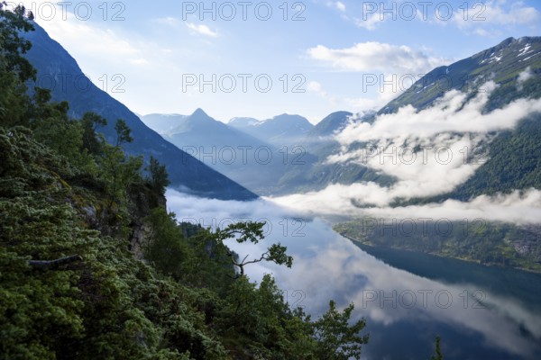 View over the Geirangerfjord, atmospheric clouds over the fjord in the morning light, Ørnesvingen