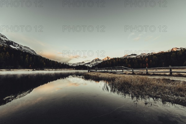 Lake Staz near Sankt Moritz in the Engadin in Switzerland. Morning atmosphere with fog in autumn.