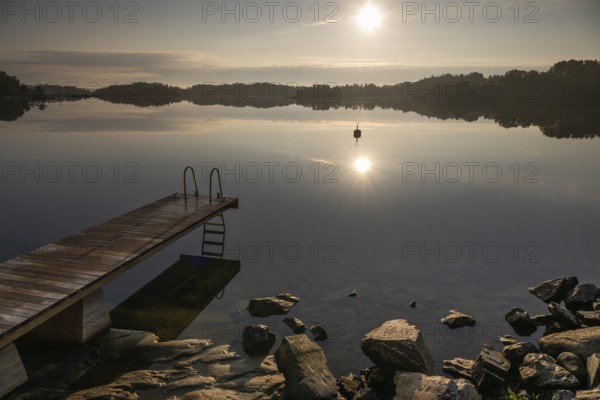 Wooden jetty with ladder, calm water surface, morning atmosphere, Kasnäsintie, Falkö Fjord, Kasnäs,