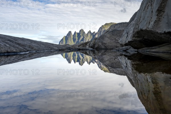 Reflection in a tidal pool, rocky coast of Tungeneset, Devil's Teeth, Okshornan, Ersfjorden, Senja