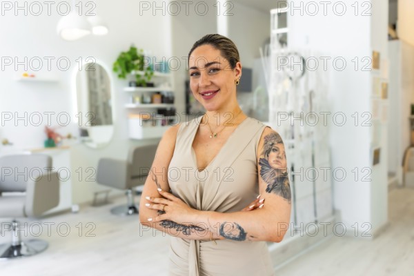 Portrait of a smiling hairdresser standing with arms crossed in her modern beauty salon, proud