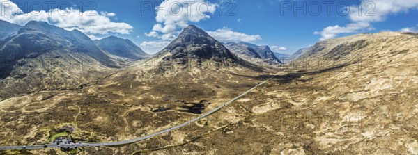 Panorama of Buachaille Etive Beag and Three Sisters in Glencoe over Moors and Road A82 from a