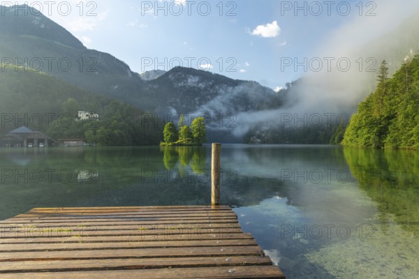 Mystical morning at Königssee in Schönau with boathouses and Christlieger. Sunrise and beautiful