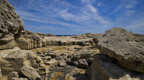 Expansive rocky landscape under a blue sky, Oasis Beach, east coast of Rhodes, Rhodes, Dodecanese,