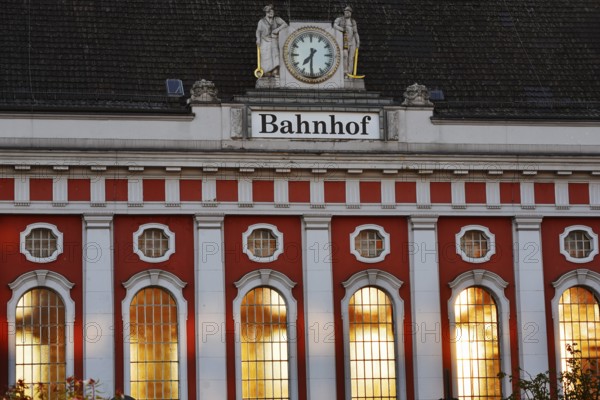 Hamm main station, façade with station clock and sculptures of a wire-drawer and a miner at the