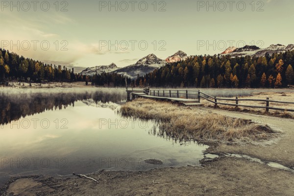 Lake Staz near Sankt Moritz in the Engadin in Switzerland. Morning atmosphere with fog in autumn.