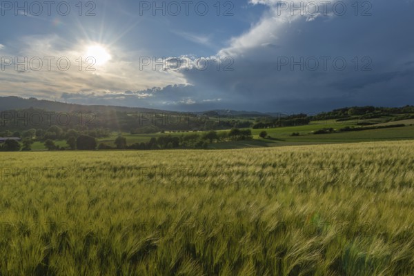Dramatic cloudy sky with approaching storm and last sunbeams, Frankenhain, dark cloud wall,