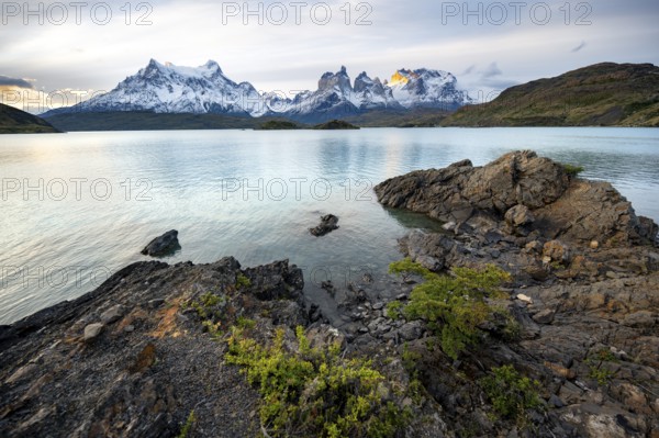 Cuernos del Paine mountain range at sunset, shore of the blue lake Lago Pehoe, Torres del Paine
