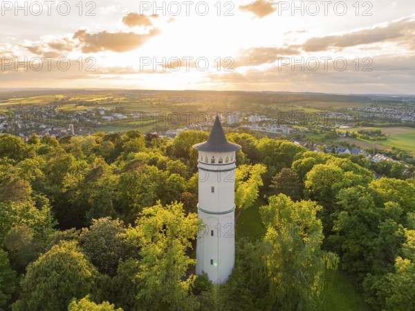 In the sunset light, a tower rises above the blossoming scenery, Engelberg Tower, Leonberg, Germany