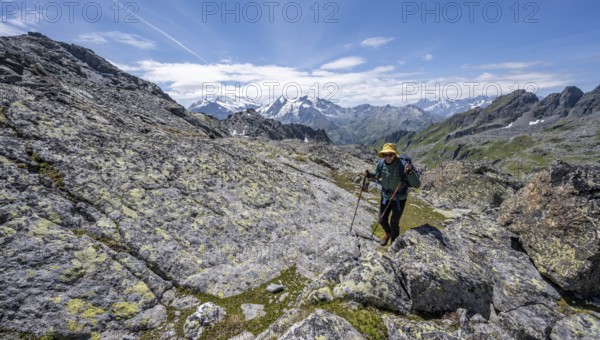 Mountaineer in rocky mountain landscape at the Col du Louvie, view of the summit of the Grand