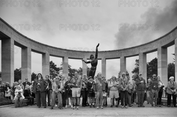 Funeral service, mourning relatives pause during the playing of the US national anthem, bronze