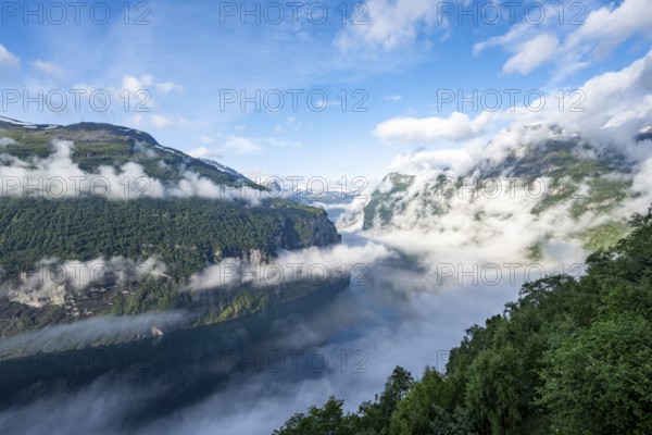 View over the Geirangerfjord, atmospheric clouds over the fjord in the morning light, Ørnesvingen