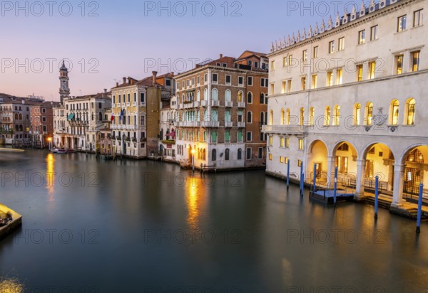 View of the Grand Canal at sunset, picturesque evening mood with illuminated palazzos on the canal