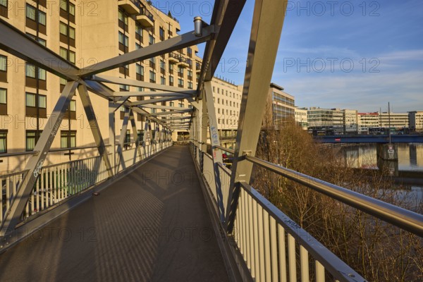 Modern architecture, footbridge, metal railing, river Saar, blue sky, cirrostratus clouds, evening