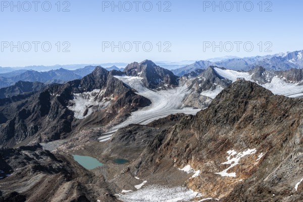 View of mountain basin with blue glacier lakes, behind summit Becher with Becherhaus, glacier