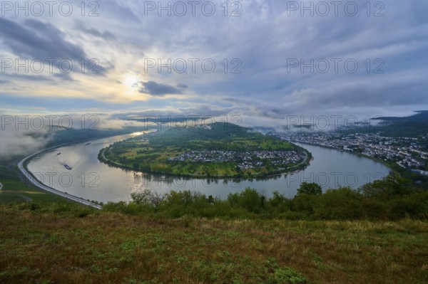 View of a river bend, surrounded by green hills and a cloudy sky. morning atmosphere, summer, Rhine