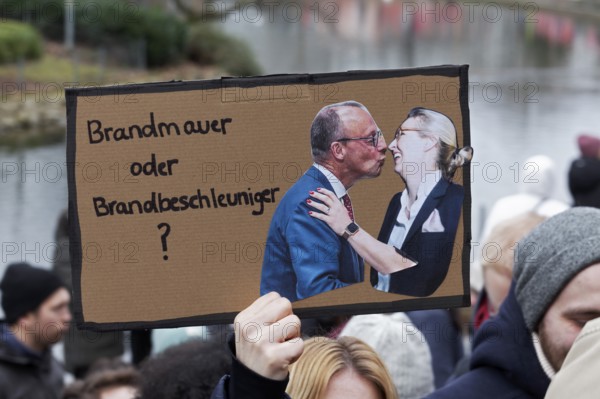 Friedrich Merz kisses Alice Weidel, banner on the topic of the firewall, demonstration against