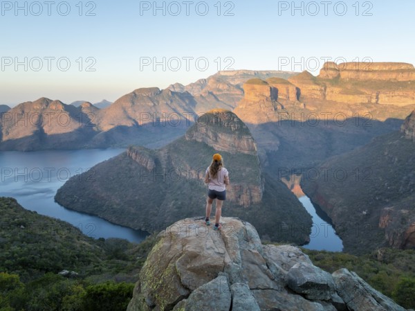 Hiker enjoying panorama, Blyde River Canyon with summit Three Rondawels, view of canyon with river