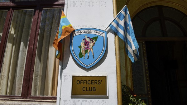 Building with sign of the officers' club, Greek flag and coat of arms, harbour area, Rhodes Town,