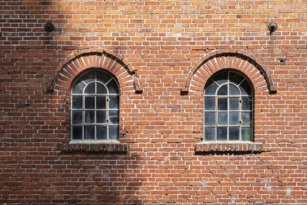 Old windows in a traditional brick wall with rustic charm and visible reflections, Stiftsmühle,