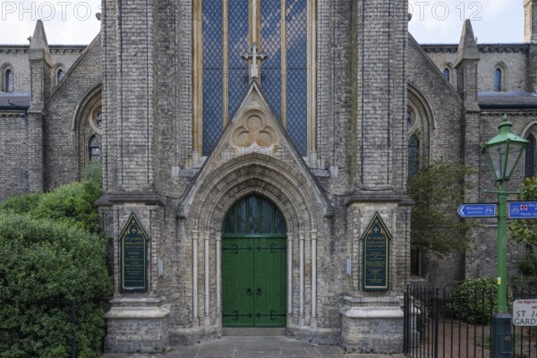 Neo-Gothic church entrance with green door, St James's Church, Norlands, architects Lewis Vulliamy,