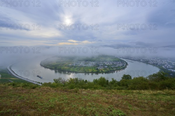 Foggy river bend, surrounded by green hills and calm morning atmosphere, summer, Rhine bend