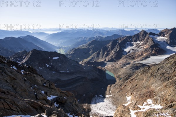 View of mountain panorama into the Ridnaun valley with blue glacier lake, ascent to the Wilder
