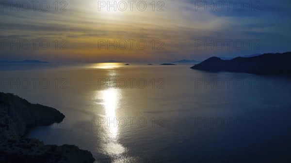 Drone shot, Fascinating sunset with light reflection in the water, Holy Week, Bay of Panormitis,
