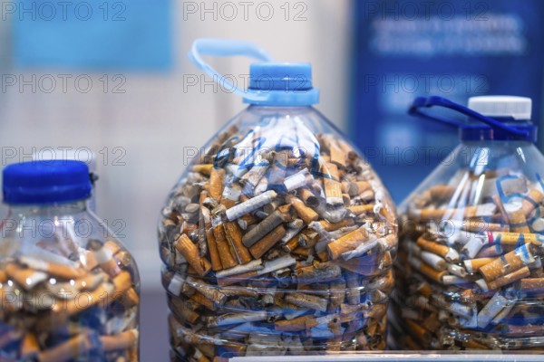 Plastic bottles filled with cigarette butts highlighting environmental pollution and the need for