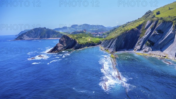 Breathtaking aerial view of the unique flysch cliffs meeting the deep blue water of the cantabrian