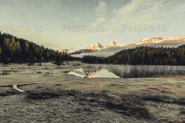 Lake Staz near Sankt Moritz in the Engadin in Switzerland. Morning atmosphere with fog in autumn.
