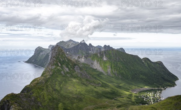 View of mountain peaks on the headland of Fjordgård with peak Segla, fjords Øyfjorden and