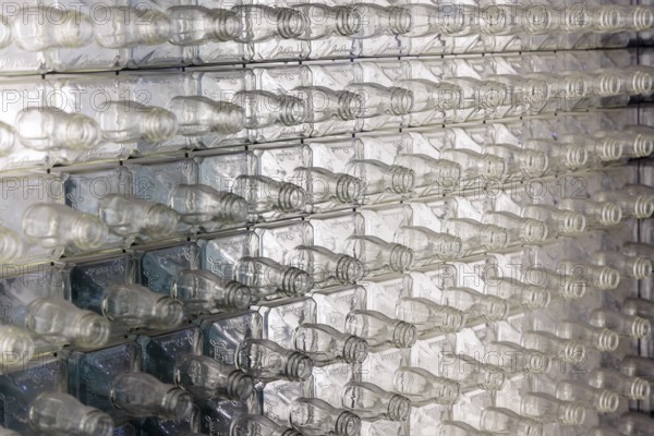 Wall of empty glass whiskey bottles at the Visitor Center of the Jack Daniel Distillery in