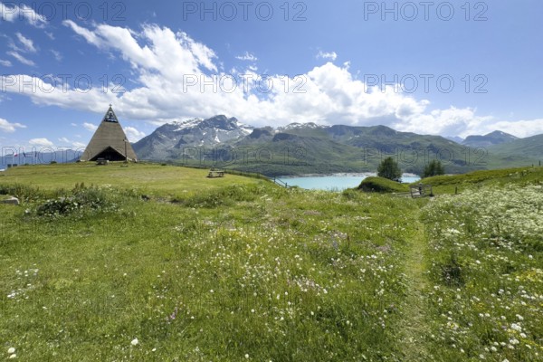 Panoramic view from plateau above Lanslebourg-Mont-Cenis to reservoir Lac du Mont Cenis left Museum