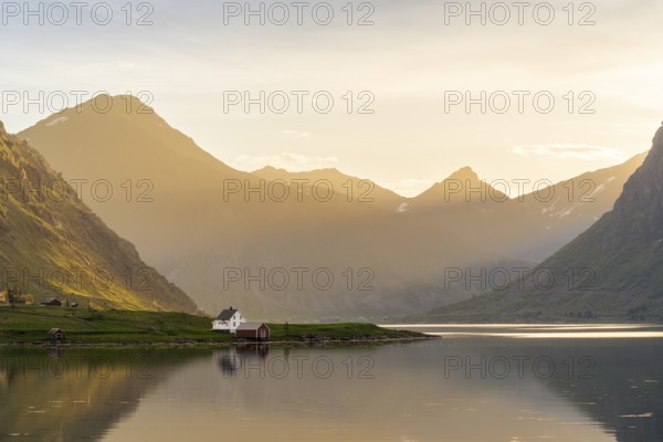 Landscape with sea and mountains on the Lofoten Islands. The fjord Flakstadpollen and some houses