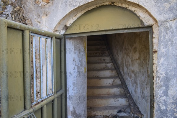 An open entrance with stairs leads into a dilapidated, secluded structure, Lost Place, Lago