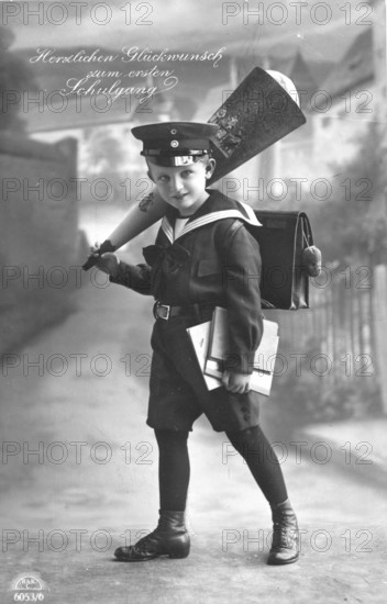 School enrolment, 1920s, A boy in school uniform with school bag and cone in a studio, Historical