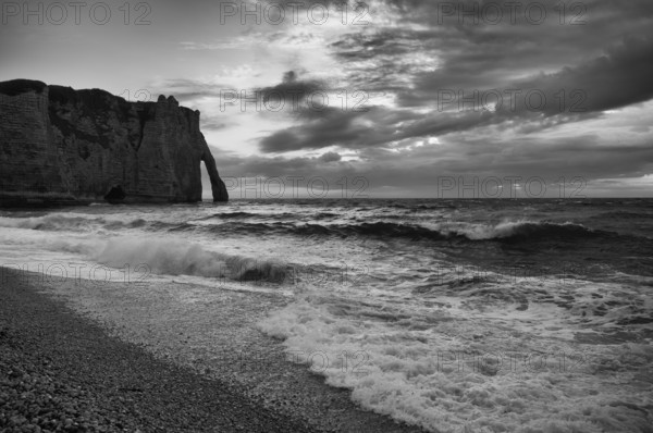 Surf in front of rock arch Falaise or Porte d'Aval, Étretat, sea, clouds, steep coast, cliffs,