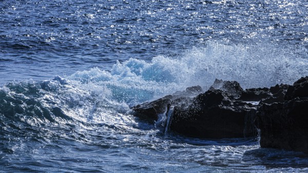 Rugged rocky coastline and foaming spray, on Stecci beach, near Capoliveri, Elba Island, Tuscan