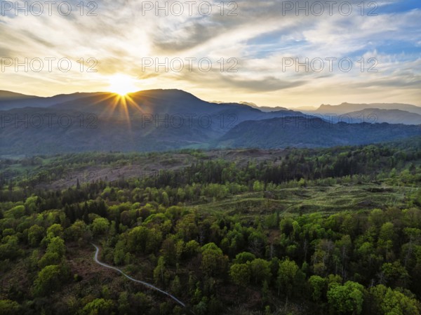 Sunset over Mountains and Coniston Water from drone, Lake District National Park, Cumbria, England,
