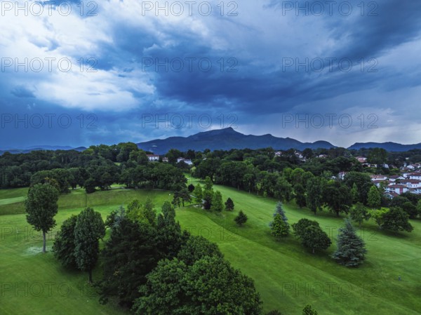 Sunset and storm clouds over Pyrenees and Saint-Jean-de-Luz from a drone, Nouvelle-Aquitaine,