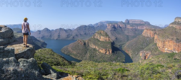 Hiker enjoying panorama, Blyde River Canyon with summit Three Rondawels, view of canyon with river
