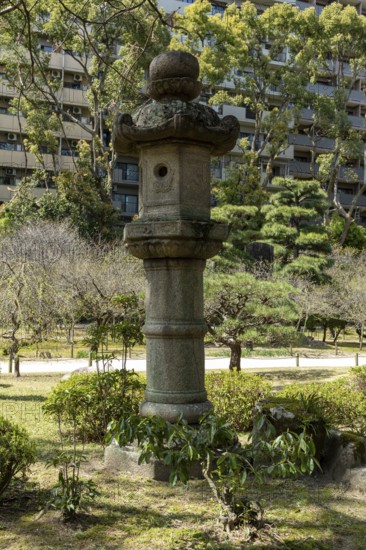 Toro stone lantern in Shukkei-en, historical Japanese strolling garden, Japanese garden, green