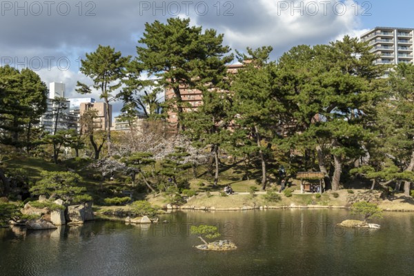 Shukkei-en with Sekisui-gan stone formation and Takuei-chi pond in spring, historical Japanese