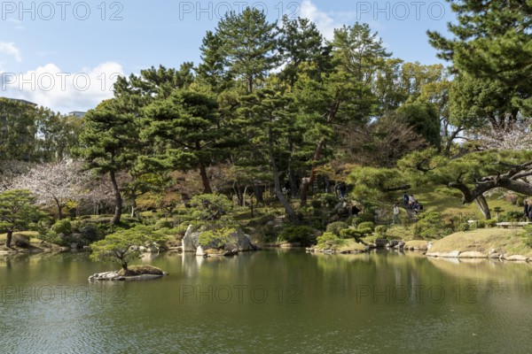 Shukkei-en with Sekisui-gan stone formation and Takuei-chi pond in spring, historical Japanese
