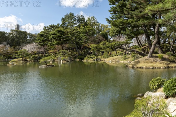 Shukkei-en with Sekisui-gan stone formation and Takuei-chi pond in spring, historical Japanese