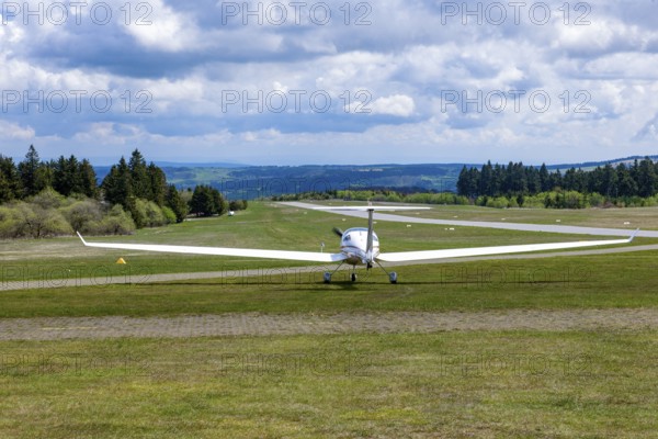 Motorised glider taxiing to the runway at Wasserkuppe airfield, Rhön, Gersfeld, Fulda district,