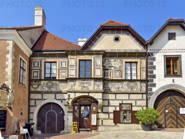 Renaissance building with frescoes and detailed stone decorations on a quiet street Mödling Lower