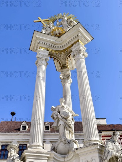 Magnificent monument with columns and statues under a bright blue sky Trinity Column Old Town Krems